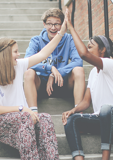 Kids smiling and talking on stairs